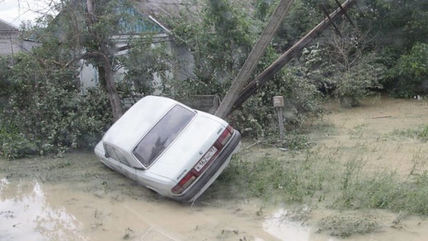 Flash floods ... a flipped car on a street of the city of Krymsk.