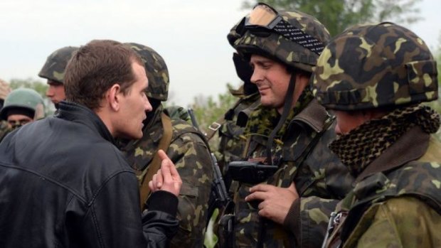A resident speaks to Ukrainian soldiers in the village of Andreevka.