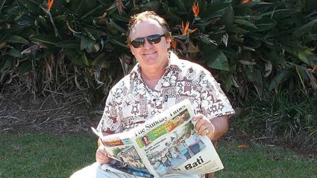 Peter Foster reading Fijian newspaper The Sunday Times.