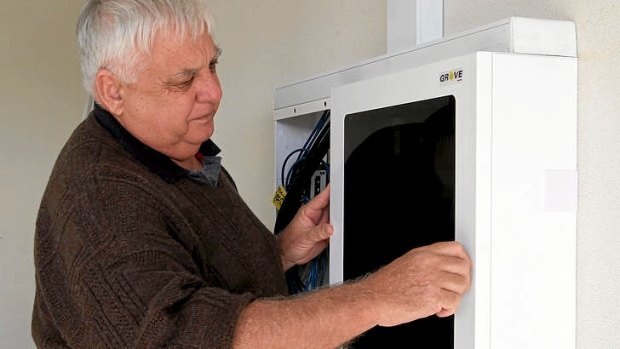 Darrell Wyatt instals the Grove cabinet for NBN, next to existing wiring, at the Telethon house at Coogee, south of Perth on August 6, 2012.