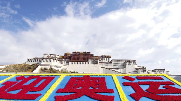 A flower-adorned billboard outside Lhasa's Potala Palace to celebrate the Beijing Olympics masks the troubled aftermath of anti-China protests held earlier this year.