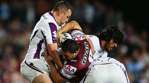 Caught: Manly's George Rose is tackled but the Sea Eagles still had too many guns for the Storm.
