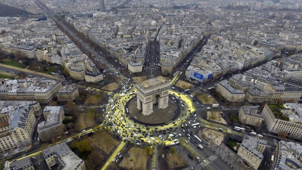 The Arc de Triomphe roundabout painted yellow by climate change activists during the Paris conference.