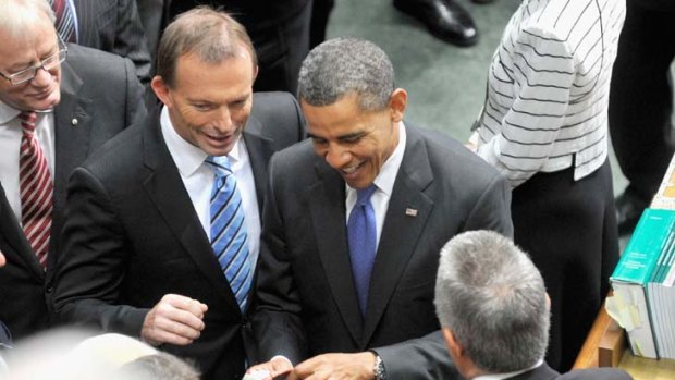Ties that bind ... Tony Abbott with Mr Obama, as he examines ties given to him by the Liberal MP Ken Wyatt, right.