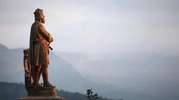 A statue of Scottish King Robert the Bruce looks out over a misty morning in Stirling, Scotland. 