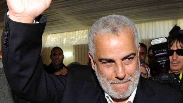 General Secretary of the Justice and Development Party (PJD), Abdelilah Benkirane,  raises his fist as he arrives at the party's headquarters in Rabat.