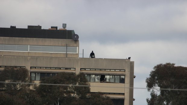 A police officer on the roof of the former CSIRO headquarters in Campbell in May this year.