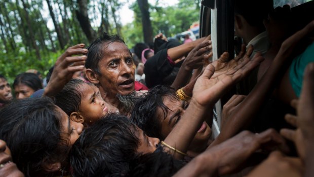 Rohingya scuffle to get aid from local volunteers at Kutupalong, Bangladesh, on Friday.