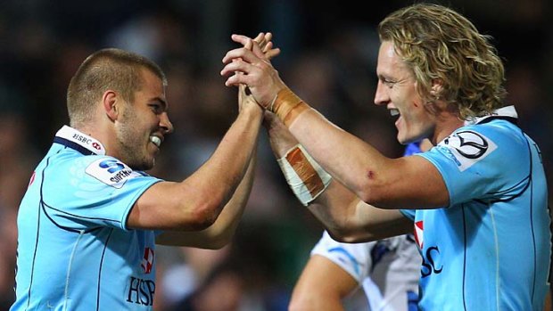 Old boys' club ... former Force players Drew Mitchell, left, and Ryan Cross celebrate one of Mitchell's two tries in Perth on Saturday night. The Waratahs have now beaten all the other four Australian franchises.