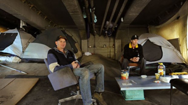 Homeless men Andrew Farrawell (left) and Robert Best in their home under an inner-Melbourne bridge.