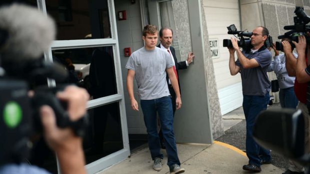 Son number one: Spec Mellencamp, centre, leaves the Monroe County Jail after being booked in to and bonded out of jail in Bloomington, Indiana.