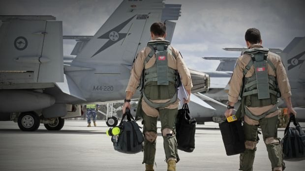 F/A-18F Super Hornet aircrew head to their aircraft in preparation for departure to the Middle East.