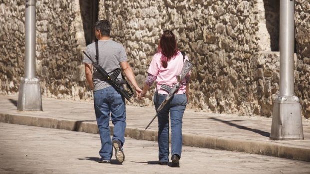 Romantic stroll: Demonstrators leave a pro-gun rally at the Alamo in San Antonio, Texas, last October.