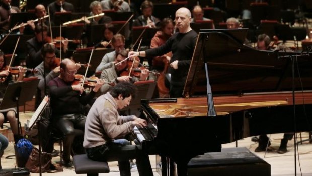 Chinese pianist Lang Lang and Estonian conductor Paavo Jarvi (centre) take part in a rehearsal of the Chamber Orchestra of Paris at the new Philharmonie de Paris.