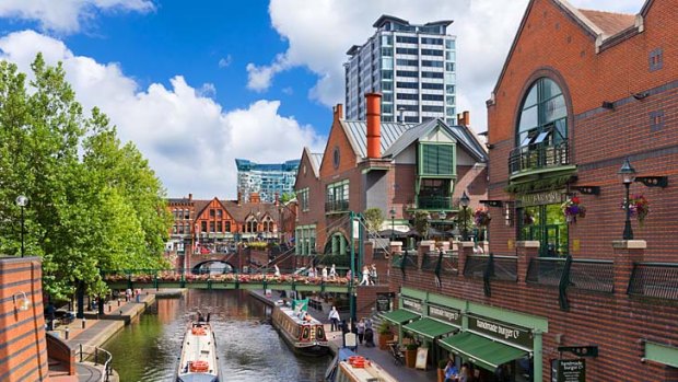 Old and the new ... Narrowboats in a Birmingham canal.