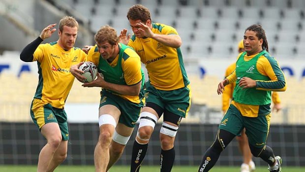 Dan Vickerman (second from left) runs the ball during a Wallabies training seesion.