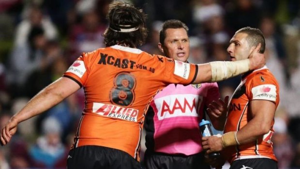 Come on ref: Robbie Farah, right, of the Tigers argues with referee Shayne Hayne as Aaron Woods, left, pulls him away
