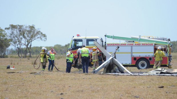 Emergency workers at the scene of the plane crash in the paddock opposite Flame Lily Adventures on Burrum Heads Rd.