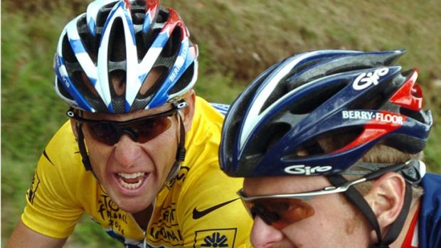 Lance Armstrong talks with US Postal teammate Floyd Landis during the 2004 Tour de France.