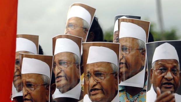 Faces in the crowd: Anna Hazare supporters wear masks of the social activist during a protest march in Agartala against government and bureaucratic corruption.