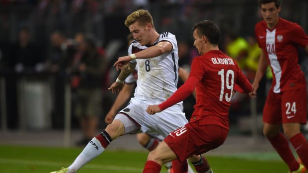 Germany's midfielder Andre Hahn (L) and Poland's defender Pawel Olkowski vie for the ball.