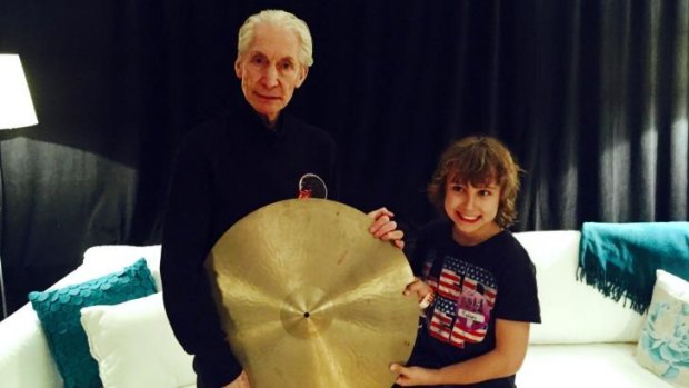 The Rolling Stones drummer Charlie Watts with fan Jagger Alexander-Erber, who gifted his rock idol with  a cymbal once owned by Jackie Dougan.