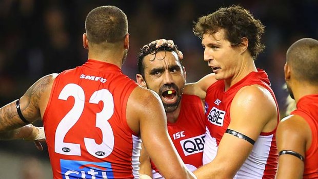 Kurt Tippett of the Swans is congratulated by Adam Goodes, Lance Franklin and Lewis Jetta after kicking a goal against Essendon.
