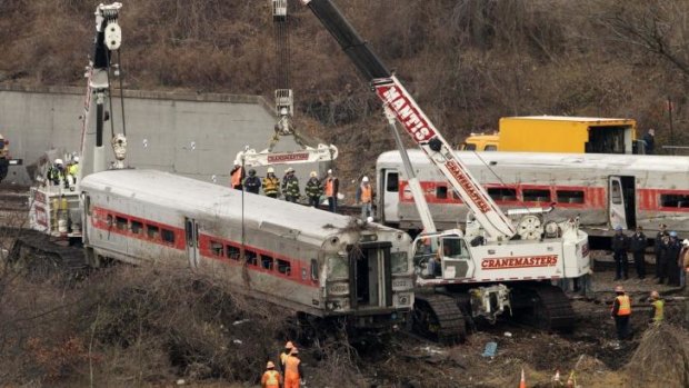 Cranes salvage the last car from from a train derailment in the Bronx section of New York.