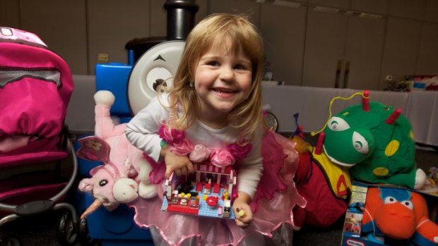 Charlotte Anderson, 3, holds the  Toy Of The Year – the Lego Friends City Park Cafe – at the Melbourne Convention and Exhibition Centre.