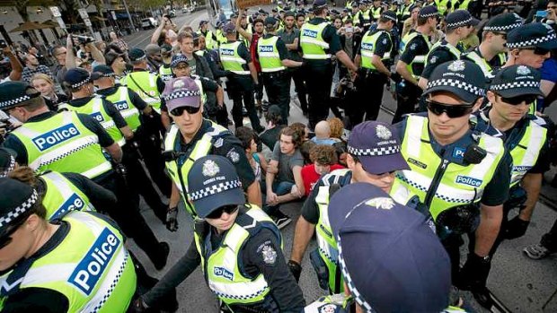 Police prepare to remove a  group of student protesters staging a sit-in at the intersection of Spring and Bourke streets near Parliament.