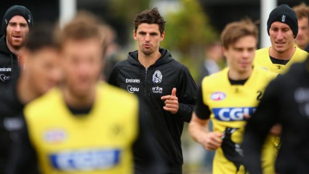 Walking wounded: Scott Pendlebury (centre) is one of a host of injured Magpies. 