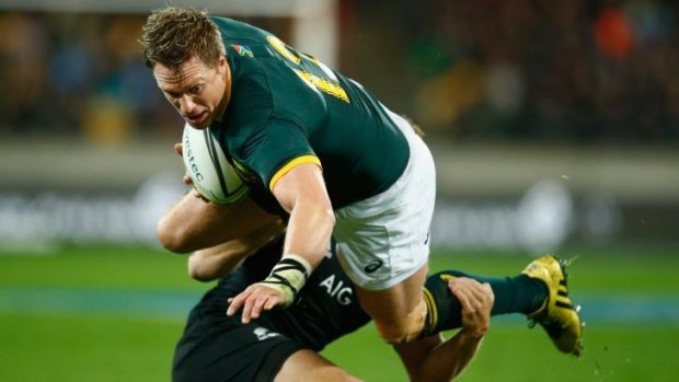 Jean de Villiers of the Springboks is tackled by Israel Dagg of the All Blacks.