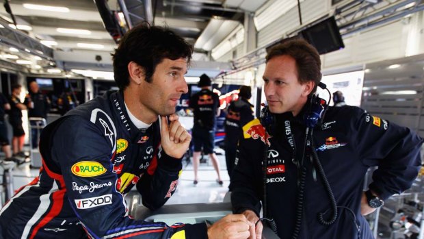 Mark Webber, left, and team boss Christian Horner in discussion before practice for the British  Grand Prix.