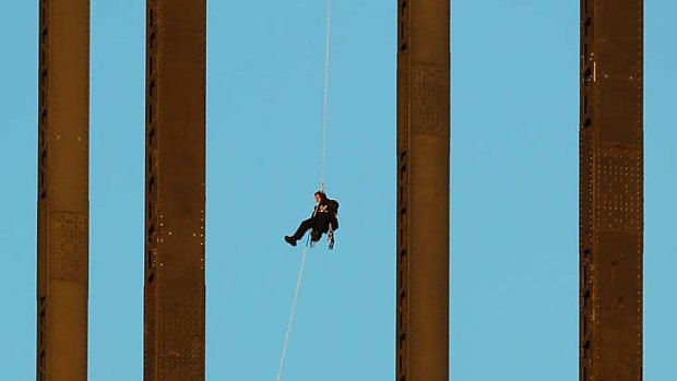 High drama ... Michael Fox on the Harbour Bridge yesterday.