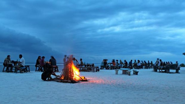 Bonfire on the beach at dusk.