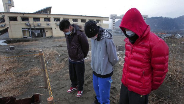 High-school students mourn the victims of the March 11, 2011 earthquake and tsunami, in Rikuzentakata, northeastern Japan, Sunday