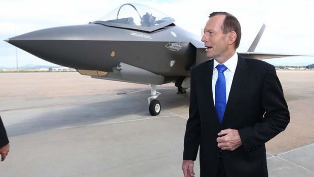 Tony Abbott with a replica of a Joint Strike Fighter.