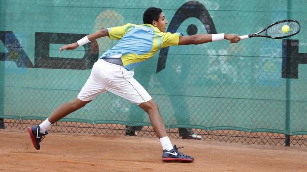 Canberra's Nick Kyrgios slides across the clay during a match at Lyneham in 2012.