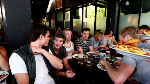 Pub grub ... Sydney players, in low-key fashion, held their end-of-season lunch yesterday at Forresters Hotel in Surry Hills. For Brett Kirk, second from left speaking to Swans ruckman Mike Pyke, it was his last Mad Monday - as a player, at least.