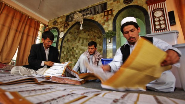 A worker counts ballots at a mosque being used as a polling station in Kabul. A final tally in the election is not scheduled to be disclosed until early September.