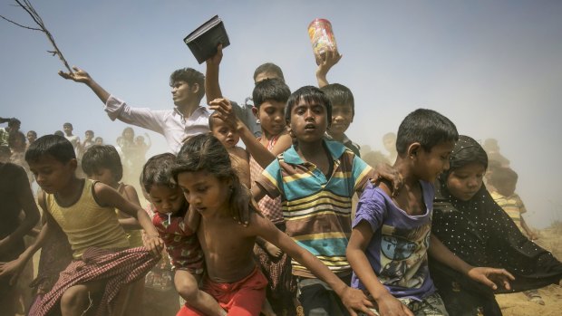Rohingya refugees run to receive relief supplies at a Rohingya refugee camp in Chittagong, Bangladesh, in February. 
