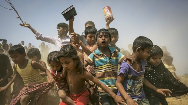 Rohingya refugees run to receive relief supplies at a Rohingya refugee camp in Chittagong, Bangladesh, in February. 