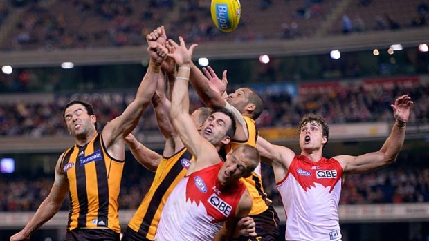 Fists of fury: A big pack flies for the ball during Hawthorn's win over Sydney at the MCG on Saturday night.