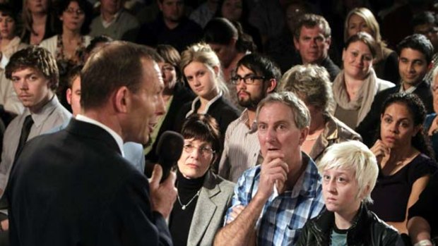 Opposition Leader Tony Abbott with local swinging voters at the Brisbane Broncos Leagues Club in Queensland.