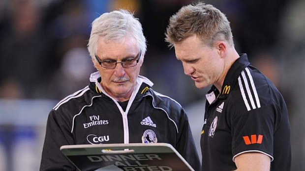 Collingwood coach Mick Malthouse devises strategy with Nathan Buckley at three quarter time in the preliminary final, 2011.