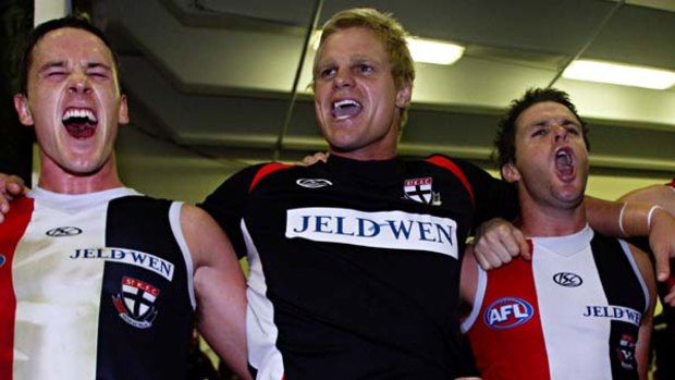 Saints captain Nick Riewoldt (centre) sings the team song with teammates Jason Blake (left) and Adam Schneider after defeating the Magpies in round three.