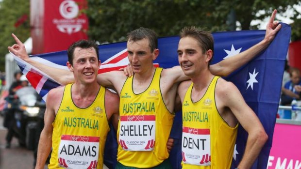 Michael Shelley, centre, celebrates his gold medal with Australian teammates Liam Adams, left, and Martin Dent, right.