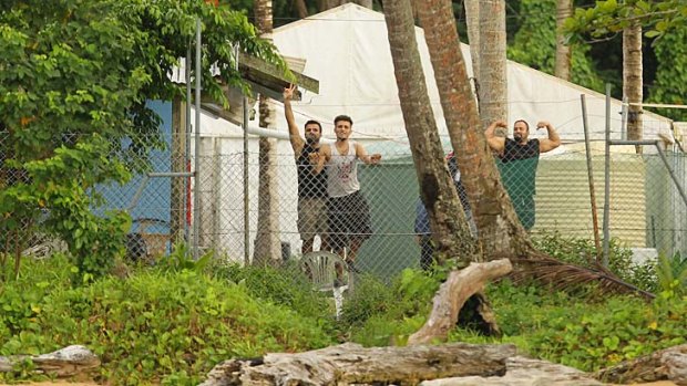 Asylum seekers behind the wire of the Manus Island detention centre.