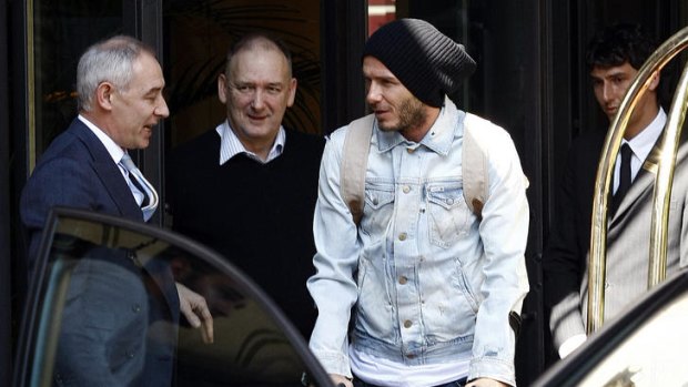 David Beckham leaves a hotel in Milan with his father Ted.