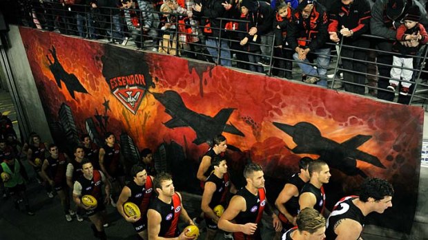 Feeling the pain: Essendon players before the game against North Melbourne.